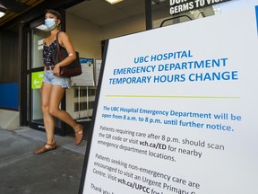 Sign announces shortened hours of the emergency room at UBC Hospital.