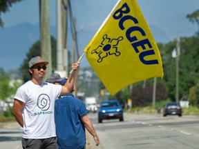 BCGEU workers picket outside the liquor distribution branch in Richmond on Monday, Aug. 22, 2022.
