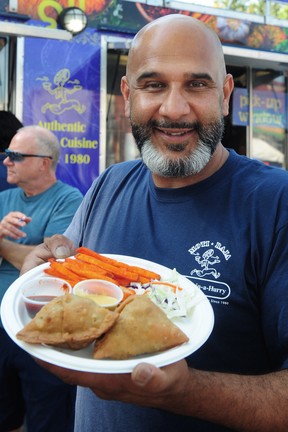 Raj Kainth  in action with the Signature Samosas during a media event to promote the new dishes available this year at the PNE in  Vancouver,  BC., on August 24, 2022.