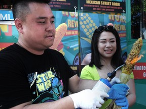 Giang Nguyen of Roasted Revolution in action with the Japanese Aburi Street Corn during a media event to promote the new dishes available this year at the PNE in Vancouver, BC., on August 24, 2022.