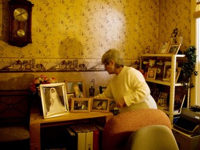 March 2008:  Lilliane Beaudion, sister of Dianne Rock-Marin, rearranges photos of Dianne in a small shrine