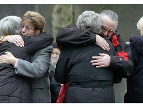 Outside the New Westminster Courthouse, where Robert (Willie) Pickton was convicted of six counts of second-degree murder. 
Victim Marnie Frey's parents hug Dianne Rock's sister and mother.