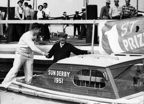 The Vancouver Sun’s Sam Cromie (left) presenting a boat to Tom Hawes, champion of the Sun Salmon Derby at Horseshoe Bay in 1951. Photo published Feb. 18, 1957.