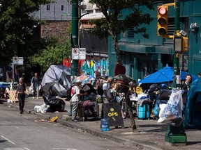 Tents line the sidewalk on East Hastings Street, Vancouver, on Tuesday, Aug. 9, 2022. The city began clearing the encampment in the Downtown Eastside on Tuesday, but there was little difference to be seen the next day.