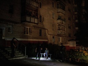 A police officer asks for the documents of a civilian during a night patrol after curfew, as Russia's attack on Ukraine continues, in Kramatorsk, Ukraine, August 5, 2022. REUTERS/Alkis Konstantinidis