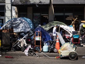 Tents line the sidewalk on East Hastings Street in Vancouver's Downtown Eastside, Thursday, July 28, 2022. People who live in a growing community of tents along the street have received notices warning that the tents and other structures are about to be removed.