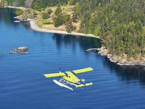 The e-Beaver flies over the water during its first point-to-point flight on Thursday, Aug. 18, 2022. HARBOUR AIR