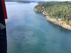 The US Coast Guard, fisheries and conservation groups are on high alert after a fishing boat capsized off San Juan Island carrying 9,800 liters of fuel.