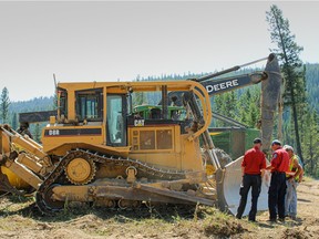 B.C. Wildfire Service personnel briefing heavy equipment operators at staging.