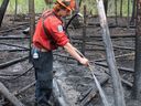 A crew member works at the Watching Creek fire in British Columbia in an Aug.5, 2022 handout photo. Cooler conditions and calmer winds have also helped crews make progress on several other wildfires around B.C.