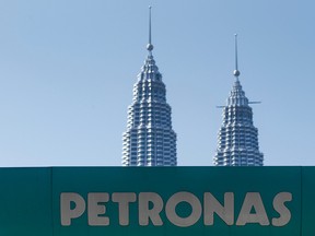 A Petronas gas station signage is pictured against Malaysia's landmark building, Petronas Twin Towers in Kuala Lumpur, Malaysia, Wednesday, March 2, 2016.