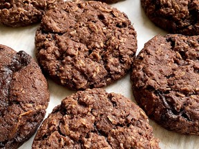 Cowboy cookies are the original power bar. They are large, hearty and chewy oatmeal-based cookies made with large flaked, old-fashioned rolled oats, shredded coconut, nuts, and chocolate chips.