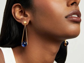 A model wears earrings from the Dean Davidson Midnight Blue Collection.