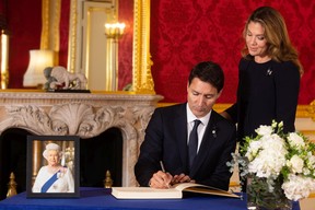 Prime Minister of Canada Justin Trudeau and his wife Sophe Trudeau sign a book of condolence at Lancaster House following the death of Queen Elizabeth II, on Sept. 17, 2022 in London, England.