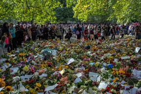 People view flowers and tributes to Queen Elizabeth II in Green Park on Sept. 18, 2022 in London, United Kingdom. Queen Elizabeth II is lying in state at Westminster Hall until the morning of her funeral to allow members of the public to pay their last respects.