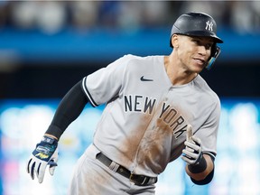 Aaron Judge of the New York Yankees runs the bases as he hits his 61st home run of the season in the seventh inning against the Toronto Blue Jays at Rogers Centre on Sept. 28, 2022 in Toronto. Judge has now tied Roger Maris for the American League record.