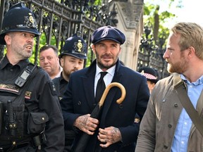 English former football player David Beckham leaves Westminster Hall, at the Palace of Westminster, in London on September 16, 2022 after paying his respects to the coffin of Queen Elizabeth II as it Lies in State. - Queen Elizabeth II will lie in state in Westminster Hall inside the Palace of Westminster, until 0530 GMT on September 19, a few hours before her funeral, with huge queues expected to file past her coffin to pay their respects.
