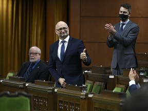 In this photo from late 2020, Minister of Justice David Lametti gives a thumbs up as he rises to vote in favour of a motion on Bill C-7, a bill which extended medically assisted death to Canadians without a terminal illness.
