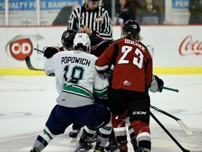 Seatle Thunderbirds forward Sam Popowich and Vancouver Giants forward Kyle Bochek jostle for position in the teams' WHL season opener Friday at the Langley Events Centre.