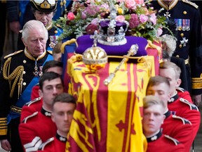 King Charles III and members of the royal family follow the coffin of Queen Elizabeth II as it is carried out of Westminster Abbey after her State Funeral on September 19, 2022.