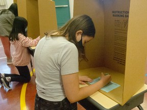 Grade 6 students at Norquay Elementary School in Vancouver fill out ballots in a mock election on Sept. 22, 2022.