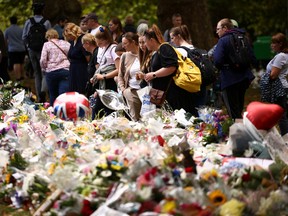 People visit floral tributes placed in Green Park near Buckingham Palace, following the passing of Britain's Queen Elizabeth, in London, Britain, September 10, 2022. REUTERS/Henry Nicholls