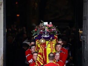 The coffin of Britain's Queen Elizabeth is carried out of Westminster Abbey after a service on the day of her state funeral and burial, in London on Monday, Sept. 19, 2022. Hannah McKay / Pool / Reuters