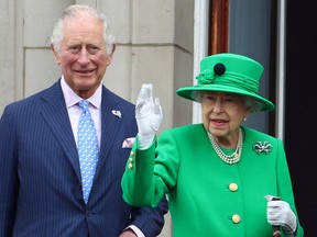 Britain's Queen Elizabeth and Prince Charles stand on a balcony during the Platinum Jubilee Pageant, marking the end of Britain's Queen Elizabeth's Platinum Jubilee celebrations, in London on June 5, 2022.