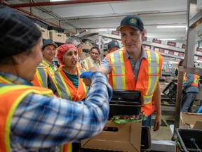 Then-Opposition leader Justin Trudeau attacked Stephen Harper in 2014 for jacking up the number of foreign workers coming to Canada to work at low-skilled jobs. But now he's doing it himself - at a faster pace, under the radar. (File photo: Trudeau visits fruit workers in Kelowna, B.C., on July 18, 2022.)