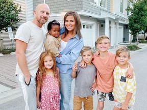Vanessa van Tol and her husband Jordan pose for a photo with their children Malaya, 6, baby Reamohetse, Maverick, 8, Cruz, 10, and Roan, 8, in this undated handout photo. With a family of seven living in a three-bedroom townhouse and a fitness business she runs from home, Vanessa van Tol is a pro at maximizing space.