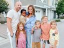 Vanessa van Tol and her husband Jordan pose for a photo with their children Malaya, 6, baby Reamohetse, Maverick, 8, Cruz, 10, and Roan, 8, in this undated handout photo. With a family of seven living in a three-bedroom townhouse and a fitness business she runs from home, Vanessa van Tol is a pro at maximizing space.