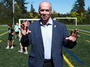 Prime Minister John Horgan gestures after his announcement of financial aid due to inflation.