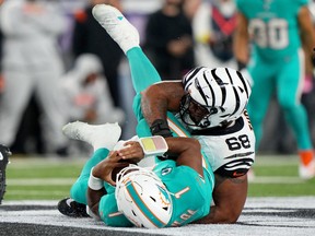 Cincinnati Bengals defensive tackle Josh Tupou (68) sacks Miami Dolphins quarterback Tua Tagovailoa (1) in the second quarter at Paycor Stadium in Cincinnati. Tagovailoa sustained a head injury on the play and left the game for treatment. Photo: Kareem Elgazzar/USA Today Sports