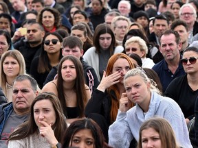 Members of the public cry as they watch the state funeral service of Queen Elizabeth II on a large screen in Hyde Park, London, on September 19, 2022.