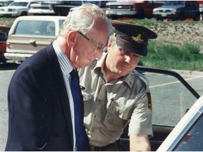 1989 file photo of Harold McIntee being led away by a Williams Lake sheriff.