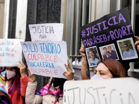Demonstrators hold up signs during a protest to demand justice for Rodrigo Ventocilla, a Peruvian graduate student at Harvard and activist for transgender rights who died on the island of Bali days after being detained for alleged cannabis possession along with his husband, outside Peru's foreign ministry building, in Lima, Peru August 26, 2022. REUTERS/Angel Ponce