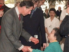 Chow Wong, a resident of St. Vincents Hospital, gets the attention of Prince Charles during a tour of the Hospital. (David Clark/PNG)