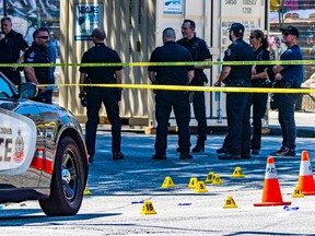 Members of the Vancouver police department attend to the site of a shooting in the Downtown Eastside on July 30, 2022.