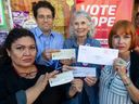 COPE Council Candidates (left to right) Nancy Trigueros, Breen Ouellette, Jean Swanson, and Tanya Webking hold party checks received in envelopes with the Concord Pacific logo at the Vancouver campaign office.