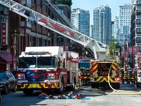 Vancouver fire fighters put out a fire in a building in the 200-block of Keefer Street in Vancouver, BC, Friday, September 9, 2022. (Photo by Jason Payne/ PNG)