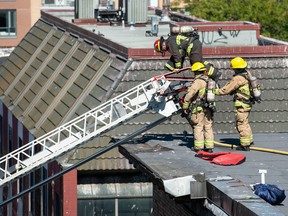 Vancouver fire fighters on the roof of Keefer Rooms in the 200-block Keefer Street in Vancouver on September 9, 2022. Photo by Jason Payne/ PNG.