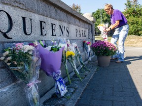 Pamela Smith lays a wreath of Lilies of the Valley at Queen's Park in New Westminster to honour the passing of Queen Elizabeth II.
