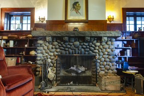 The den has a river rock fireplace and six foot fir panelling.