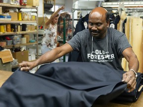 Thavakumar Sellappah works on a uniform at Claymore Custom Clothiers Wednesday, September 21, 2022. Uniforms for first responder from across Canada are made by hand by a workforce that come from around the world at Claymore in Vancouver, BC.
