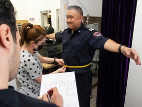 Vancouver Fire and Rescue services training officer Wade Tabata is fitted for a uniform at Claymore Custom Clothiers Wednesday, September 21, 2022. Uniforms for first responder from across Canada are made by hand by a workforce that come from around the world.