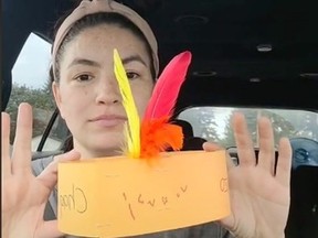 Sam Sinclair shows the feather "headdress" her son's preschool made for Truth and Reconciliation Day in a TikTok video.