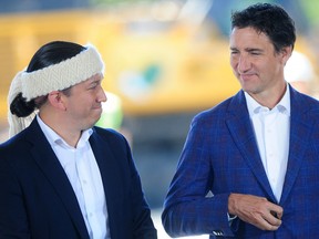 Sḵwx̱wú7mesh Úxwumixw Council President Khelsilem chats with Prime Minister Justin Trudeau at an advertisement for Squamish Nation's Sen̓áḵw development in Kitsilano on Tuesday, September 6.  The federal government announced a $1.4 billion low-interest construction loan for the project.
