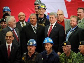 Former prime minister Stephen Harper responded to a 2014 outcry against over-relying on temporary workers. He sharply reduced their number and brought in laws that encouraged employers to improve working conditions and hire more people who were either born in Canada or had become permanent residents. (Here. Harper poses with boilermakers and Armed Forces members in Edmonton on Jan. 6, 2012.