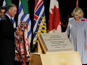 Prince Charles and Camilla, Duchess of Cornwall, unveil a plaque which commemorates the Royal’s visit to the Salt Building in the Olympic and Paralympic Village in Vancouver on Nov. 7, 2009. (Arlen Redekop/PNG)