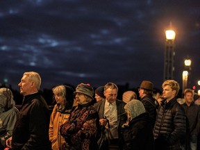 People queue on Lambeth Bridge to pay their respects following the death of Queen Elizabeth II, in London, England, September 16, 2022.